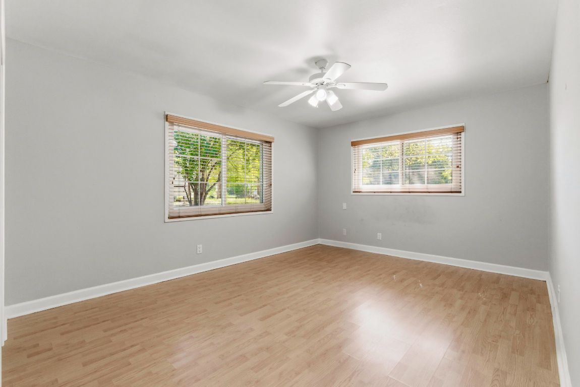 1504 West 39th 1/2 Street Austin, TX 78756 - Photo 14 of 23 a view of an empty room with a window and wooden floor