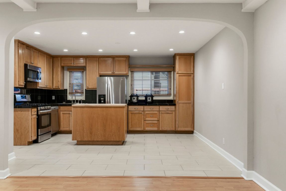 1504 West 39th 1/2 Street Austin, TX 78756 - Photo 2 of 23 a kitchen with stainless steel appliances granite countertop a stove a sink and a refrigerator