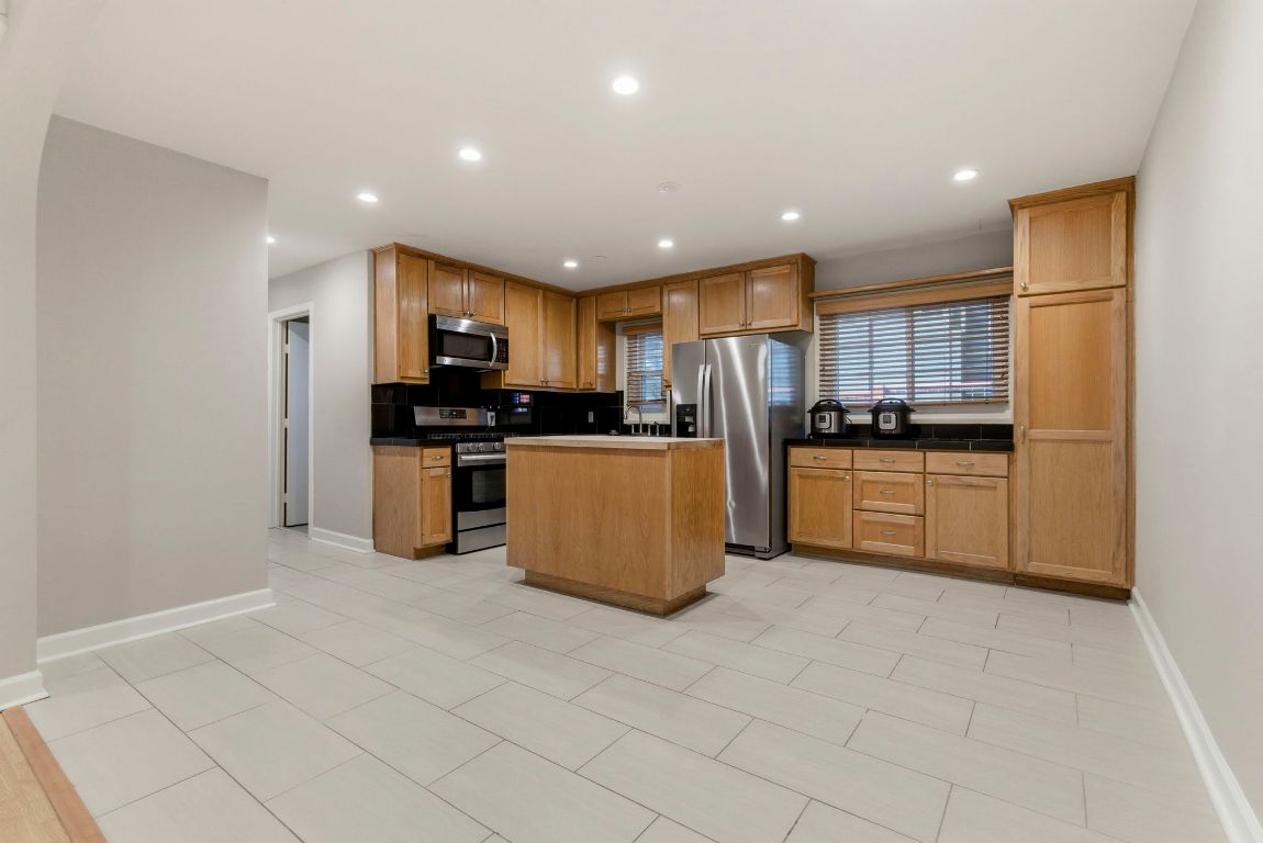 1504 West 39th 1/2 Street Austin, TX 78756 - Photo 10 of 23 a kitchen with stainless steel appliances granite countertop a refrigerator a stove top oven a sink and dishwasher