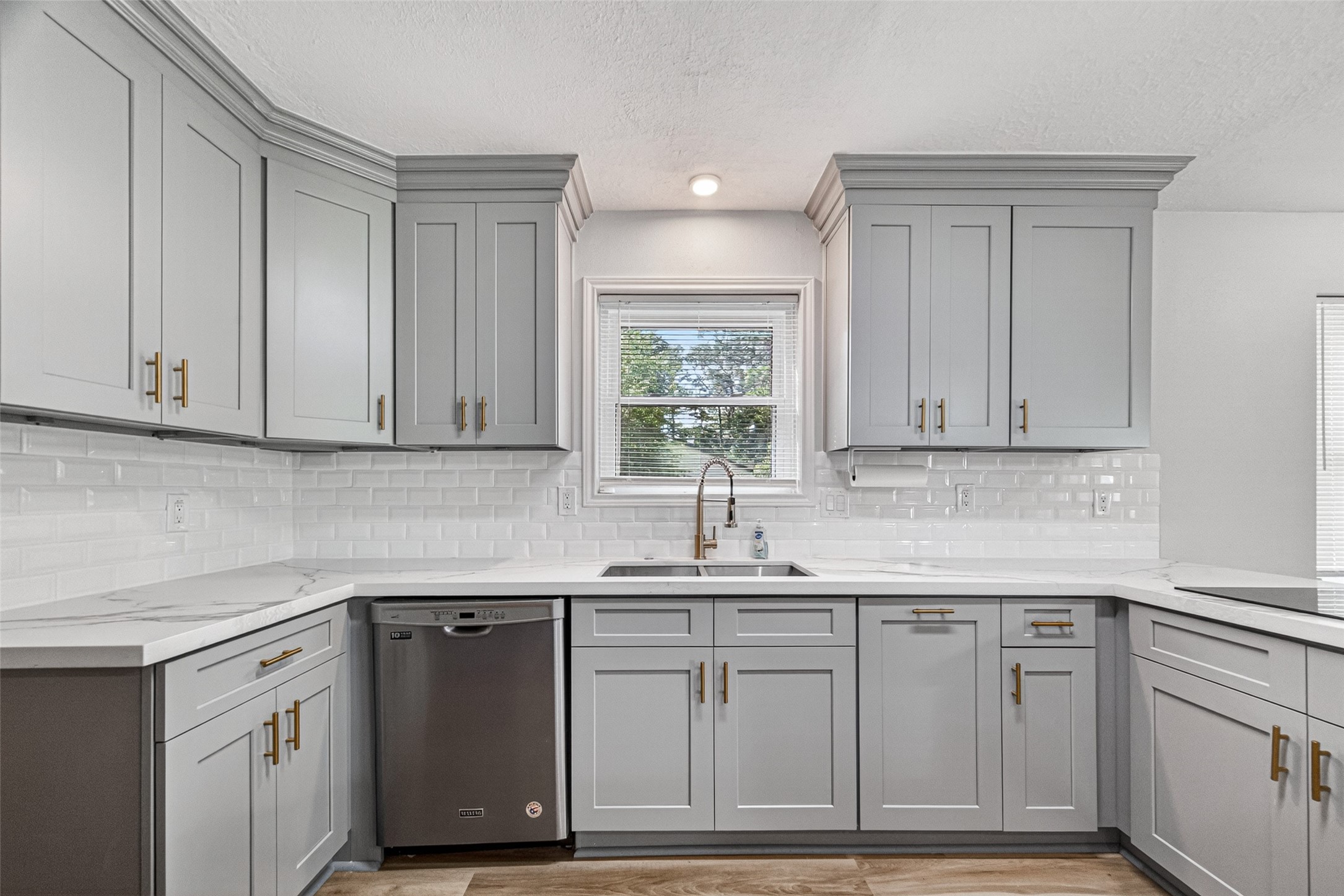 25503 Foxbriar Lane Spring, TX 77373 - Photo 4 of 45 a kitchen with stainless steel appliances granite countertop a sink and cabinets with wooden floor