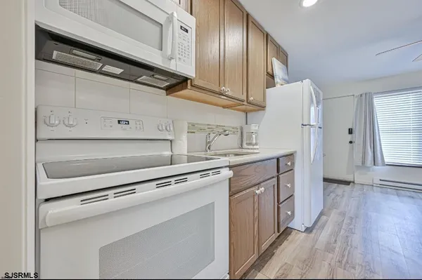a kitchen with stainless steel appliances a stove and a refrigerator