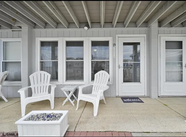 a front view of a house with outdoor seating
