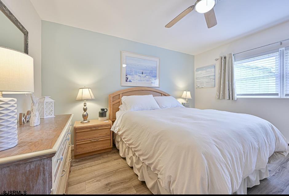 413 East Brigantine Avenue, Unit 28 Brigantine, NJ 08203 - Photo 20 of 20 a bedroom with a large bed and a chandelier