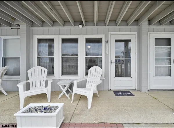 a front view of a house with outdoor seating