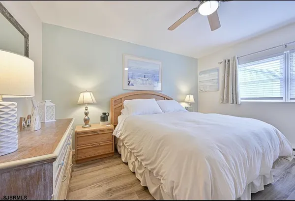 a bedroom with a bed and a large mirror