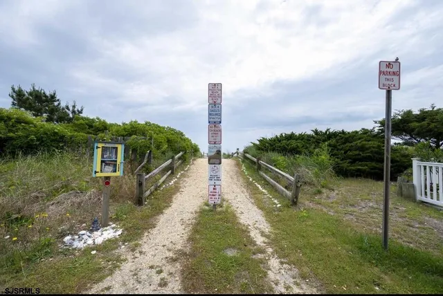 a view of a house with a yard and lake view