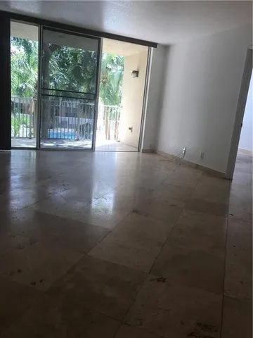 a view of an empty room with a floor to ceiling window