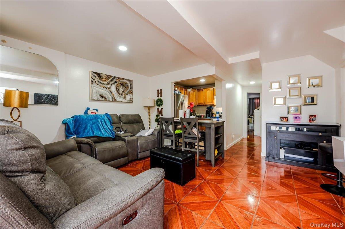 10010 133rd Avenue Queens, NY 11417 - Photo 13 of 22 a living room with furniture and a flat screen tv