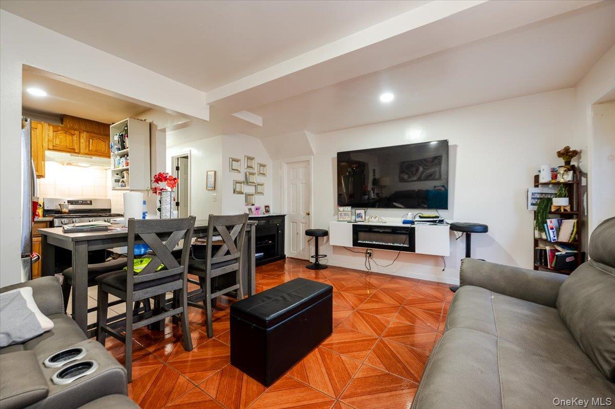 10010 133rd Avenue Queens, NY 11417 - Photo 14 of 22 a living room with furniture and a flat screen tv