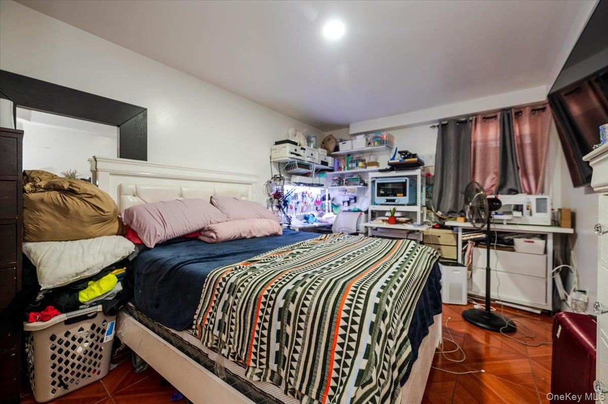 10010 133rd Avenue Queens, NY 11417 - Photo 16 of 22 a bed room with a bed and a chair