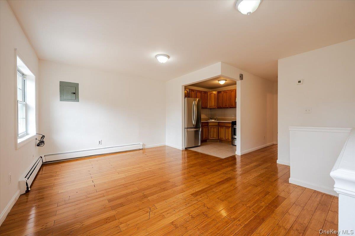 10010 133rd Avenue Queens, NY 11417 - Photo 3 of 22 an empty room with wooden floor and windows