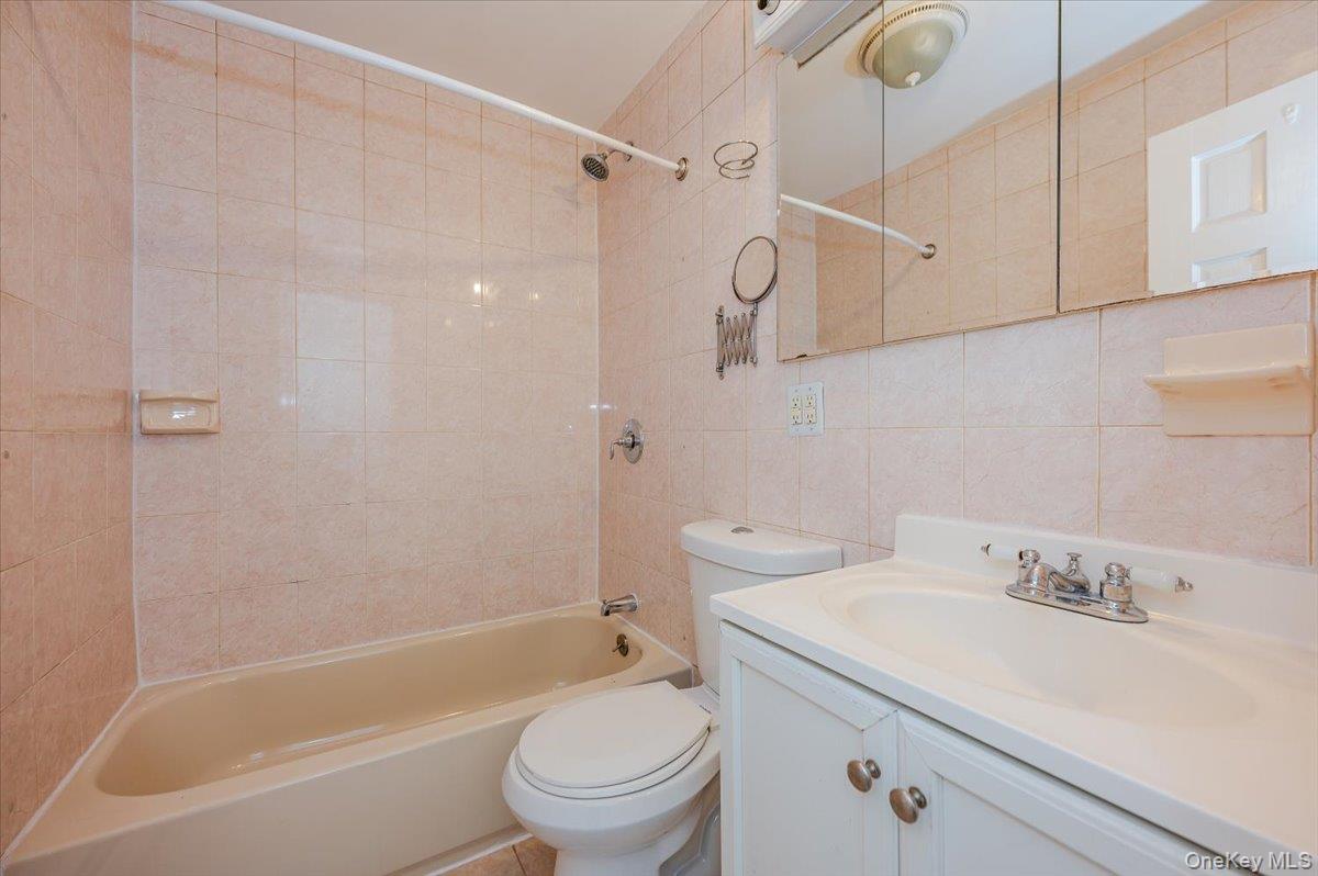 10010 133rd Avenue Queens, NY 11417 - Photo 6 of 22 a bathroom with a sink a toilet and shower