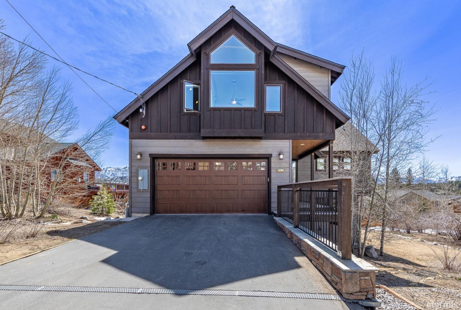 a front view of a house with garage and yard