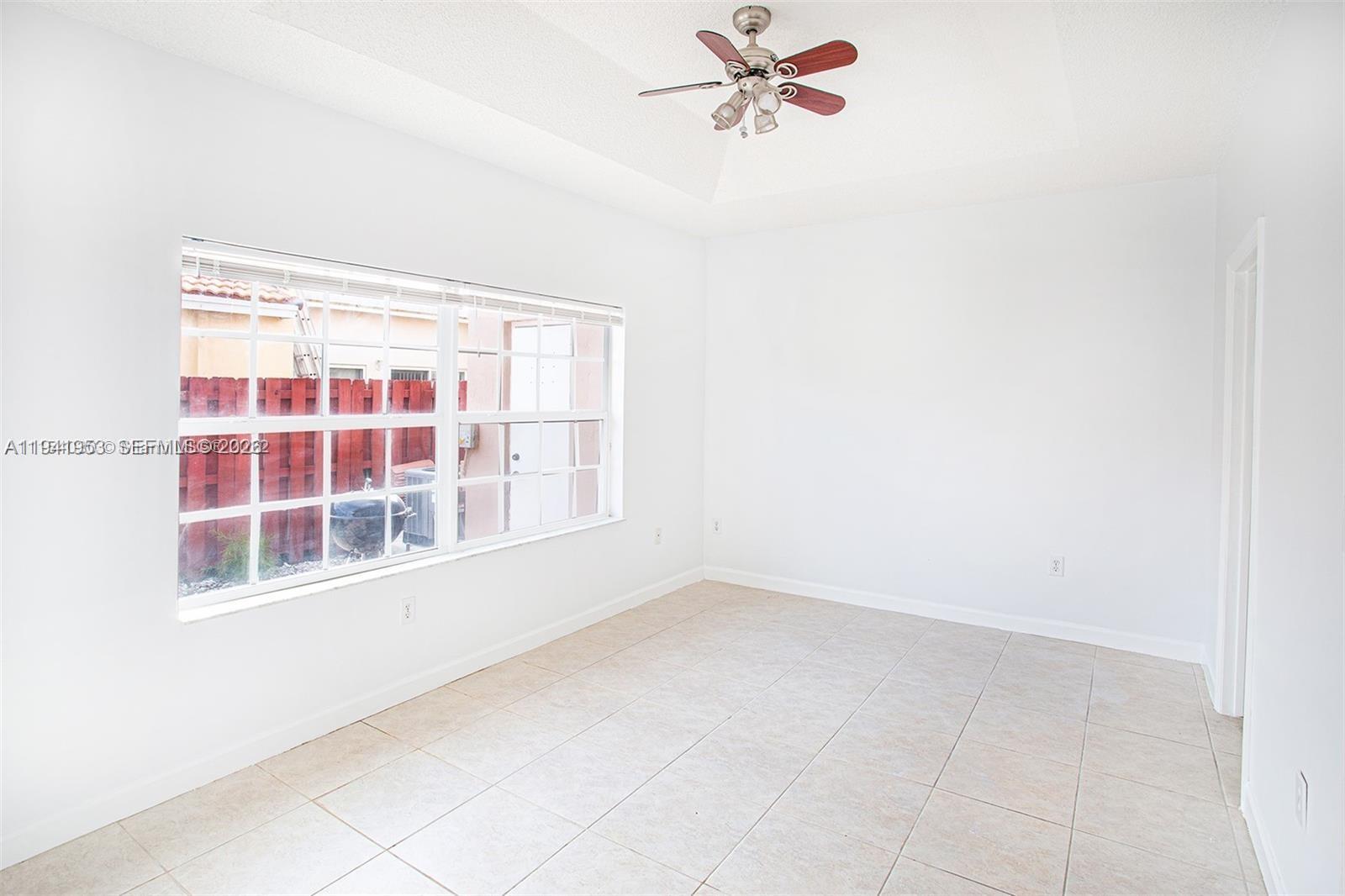 16222 Southwest 102nd Terrace Miami, FL 33196 - Photo 17 of 32 a view of an empty room with a window