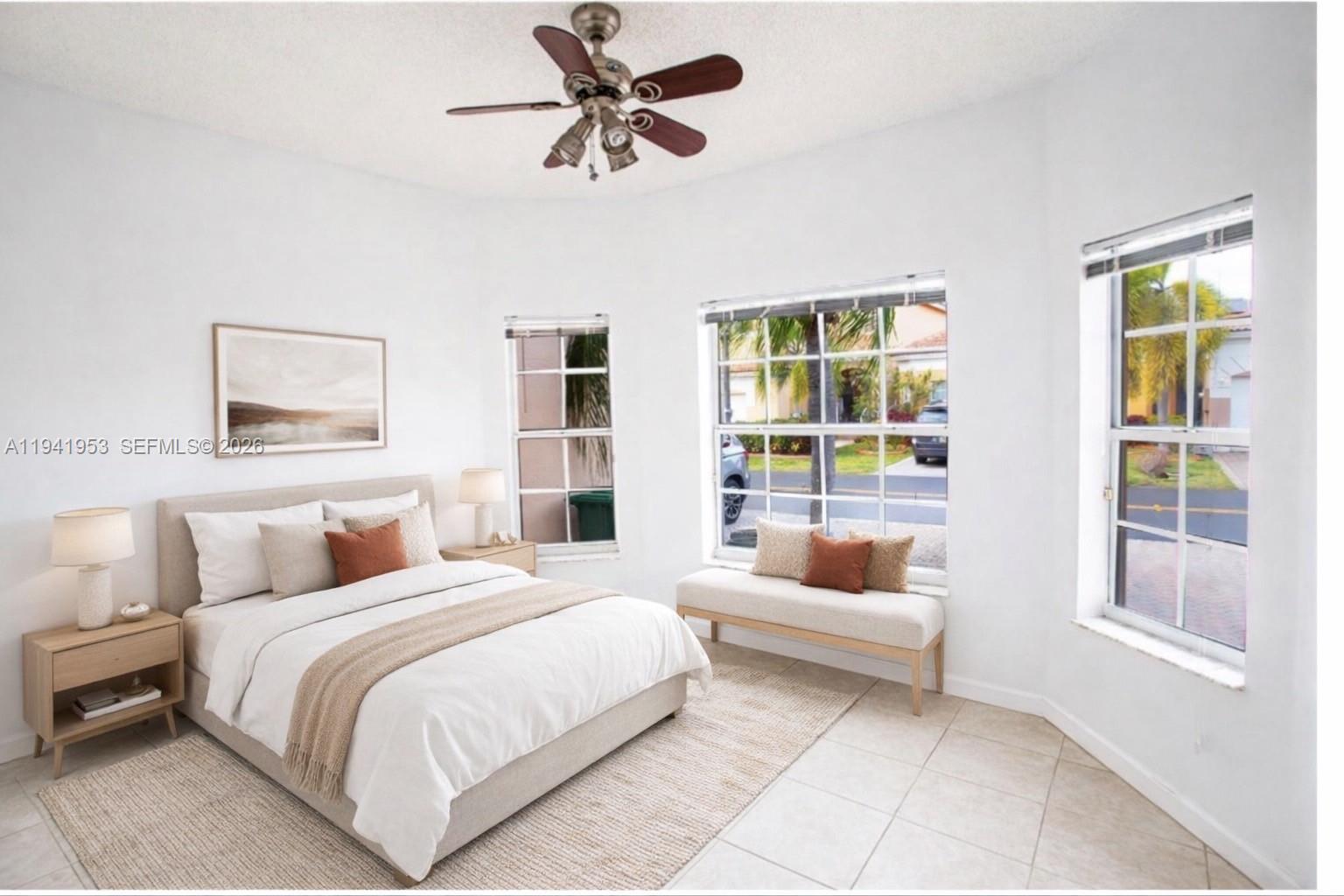 16222 Southwest 102nd Terrace Miami, FL 33196 - Photo 28 of 32 a bedroom with a large bed and a window