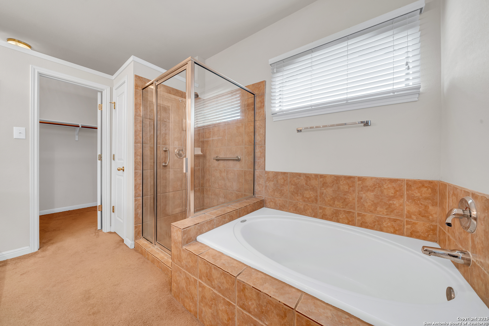 9243 McCafferty Drive Helotes, TX 78023 - Photo 15 of 40 a bathroom with a bathtub and a shower