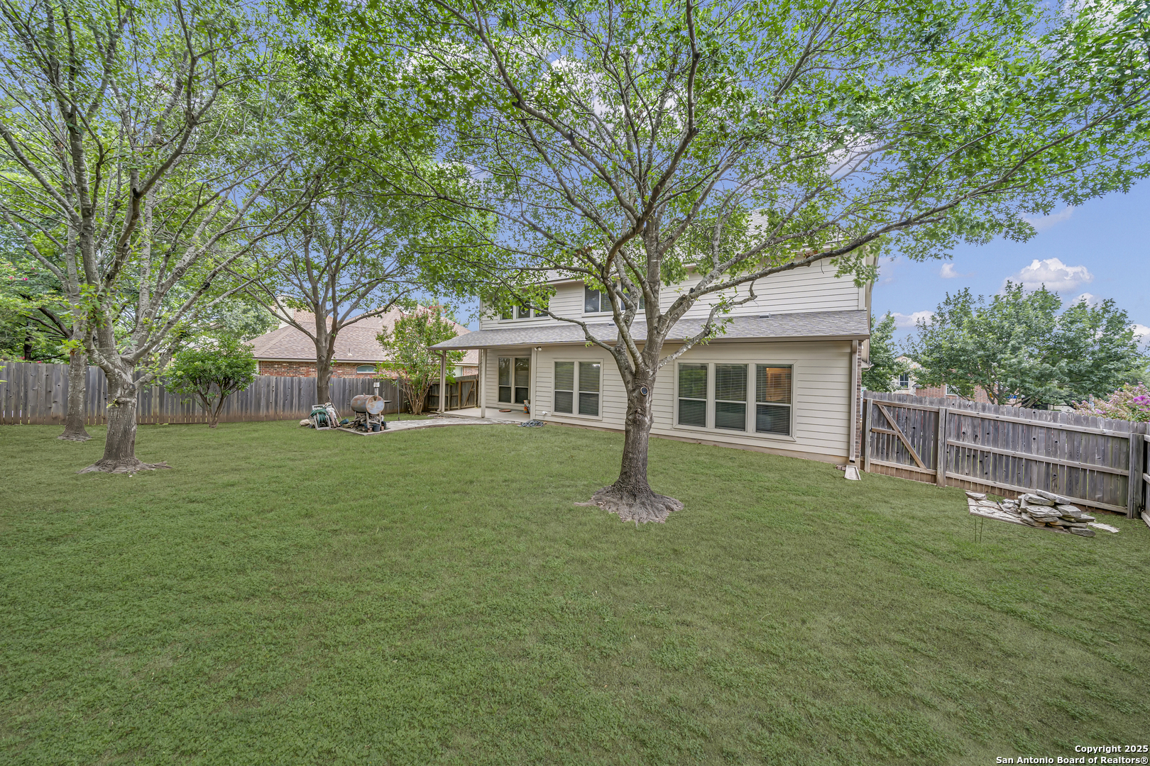 9243 McCafferty Drive Helotes, TX 78023 - Photo 28 of 40 a front view of a house with a garden