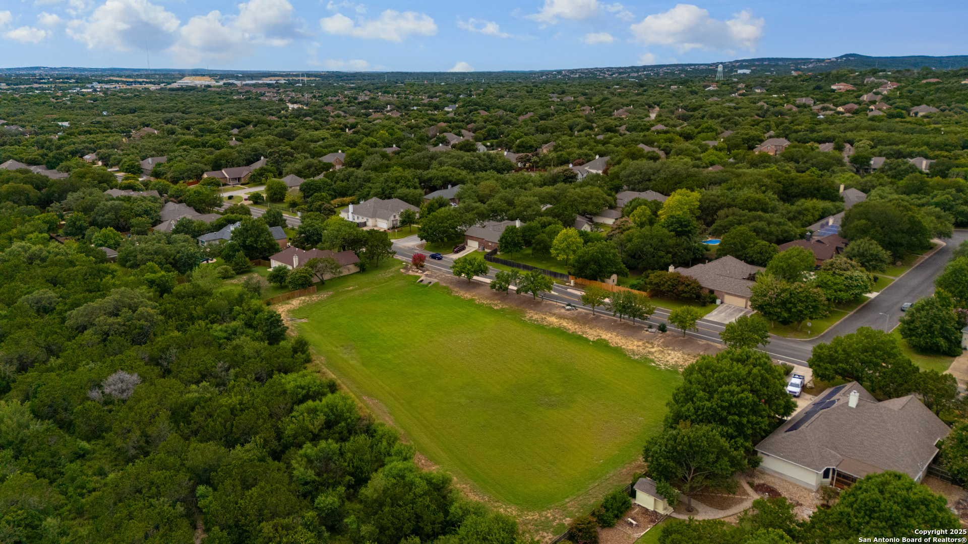 9243 McCafferty Drive Helotes, TX 78023 - Photo 34 of 40 an aerial view of residential houses with outdoor space and trees