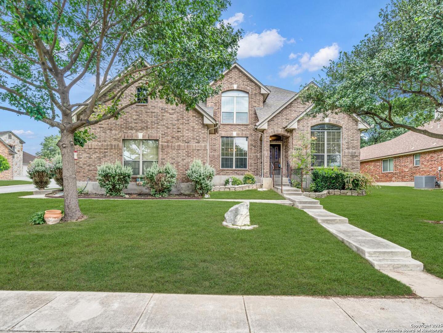 9243 McCafferty Drive Helotes, TX 78023 - Photo 39 of 40 a front view of a house with garden