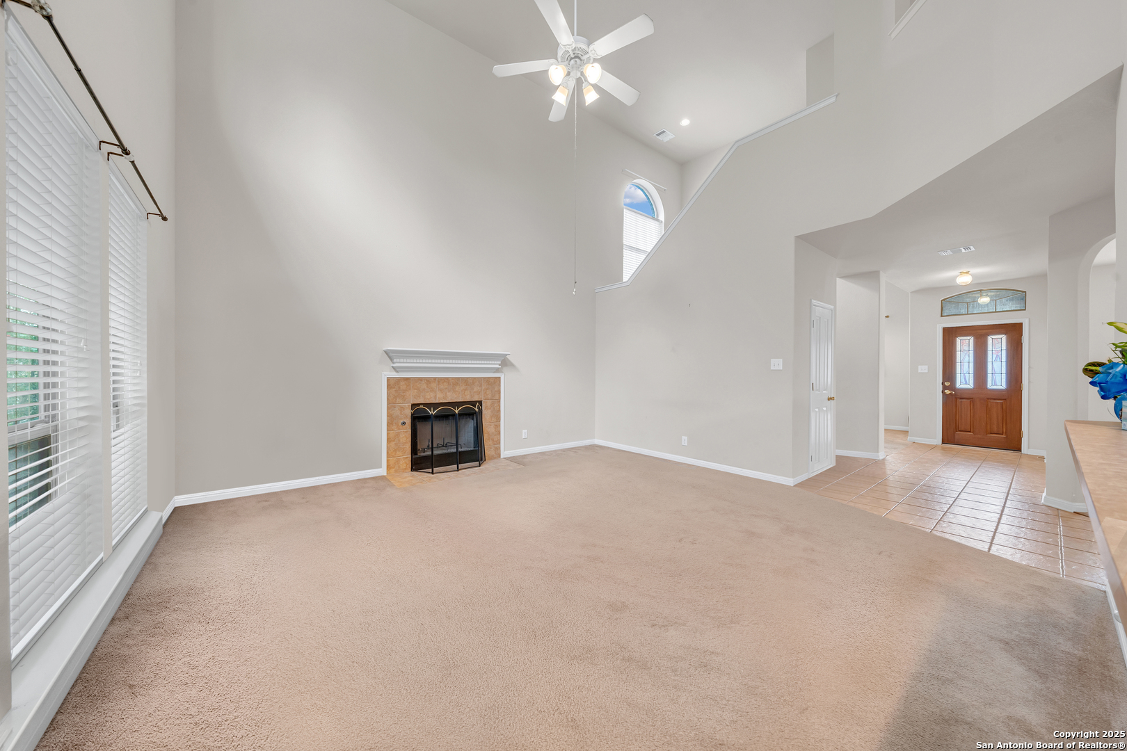 9243 McCafferty Drive Helotes, TX 78023 - Photo 7 of 40 an empty room with fan and fireplace