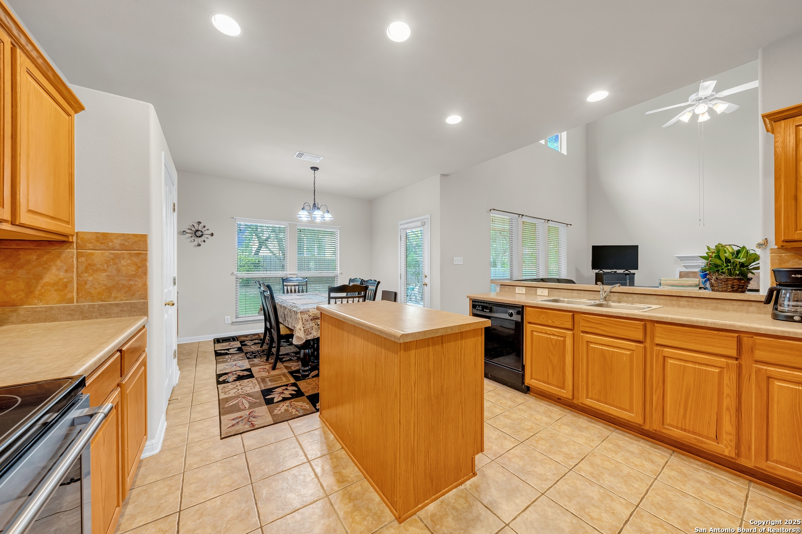 9243 McCafferty Drive Helotes, TX 78023 - Photo 8 of 40 a kitchen with cabinets and chairs