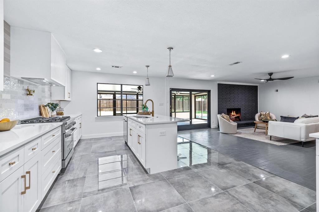 a large white kitchen with cabinets