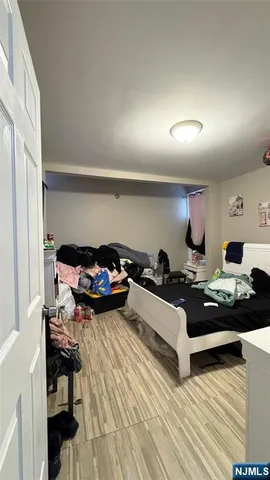 a view of empty room with wooden floor and furniture