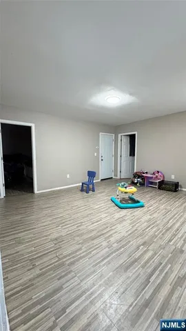 a bedroom with furniture and a wooden floor