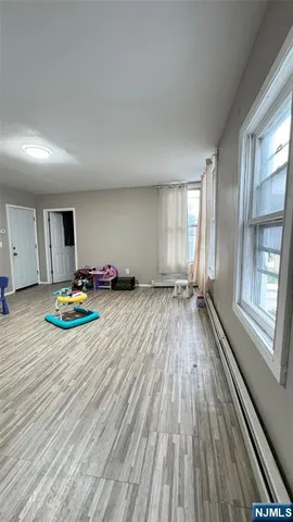 a bedroom with a bed and a view of kitchen