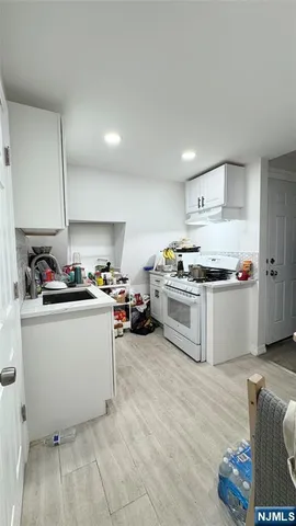 a kitchen with white cabinets and white appliances