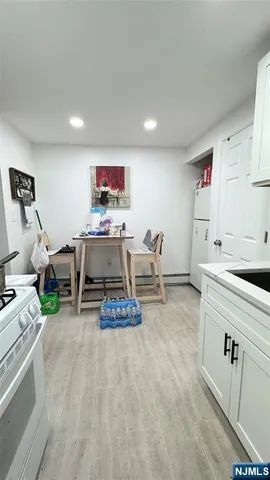 a bedroom with a bed and a view of kitchen
