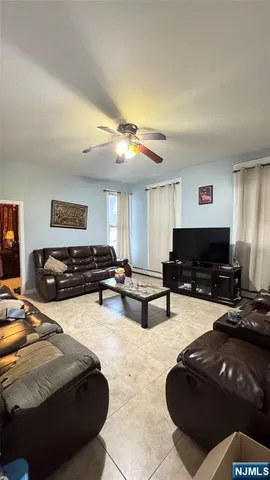 a living room with furniture and a piano
