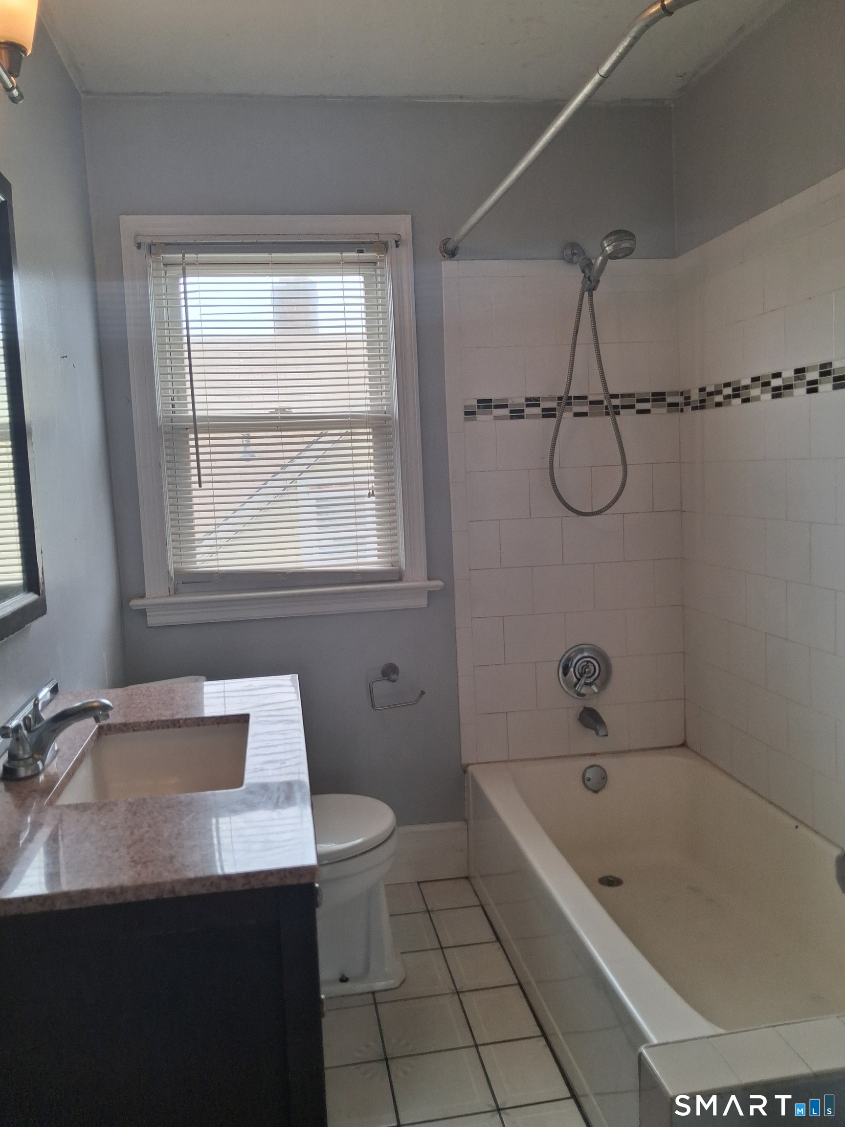 26 4th Street Hamden, CT 06514 - Photo 26 of 40 a bathroom with a tub a sink a window and a shower
