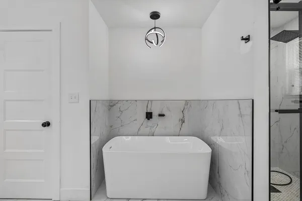 a bathroom with a bathtub and shower