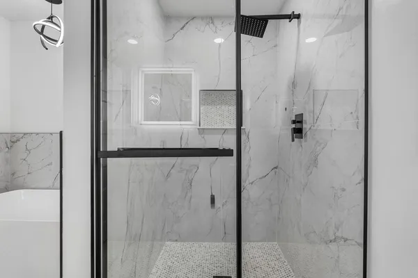 a bathroom with a shower and a mirror
