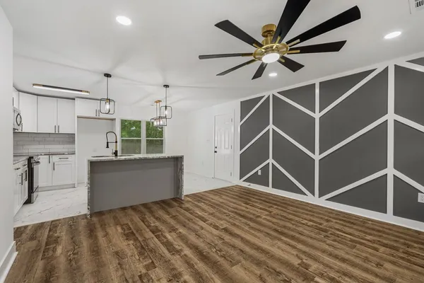 a view of a kitchen with microwave and cabinets