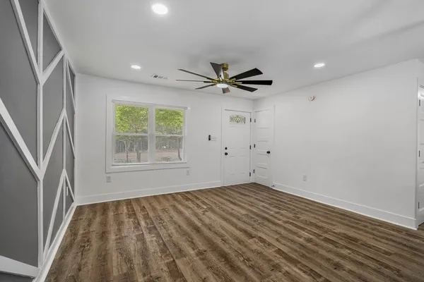 wooden floor in an empty room with a window
