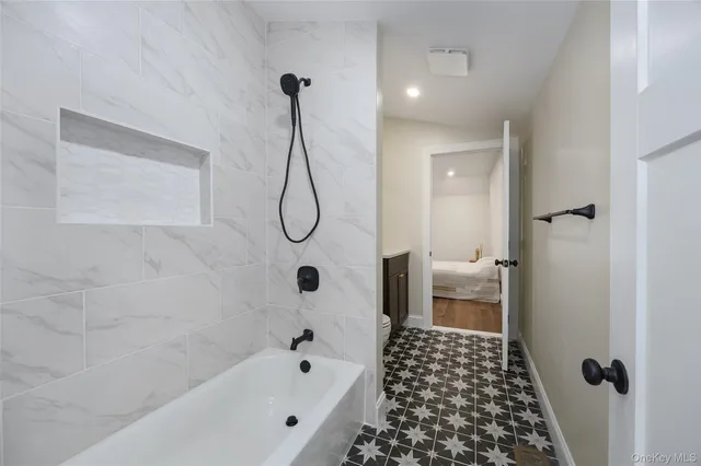 a bathroom with a bathtub and shower