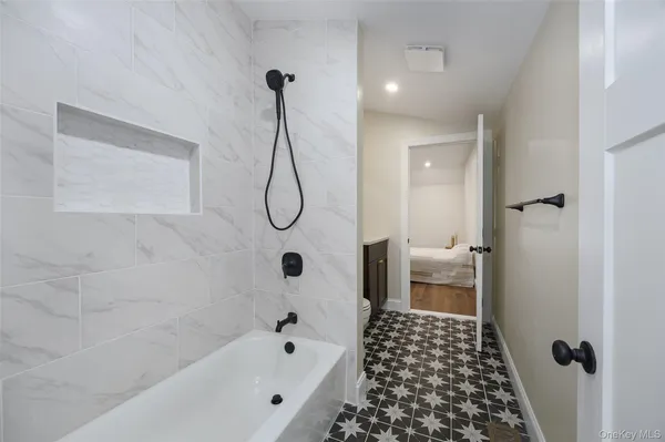 a bathroom with a bathtub and shower