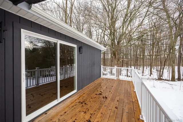 a view of balcony with wooden floor and fence