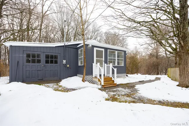a view of a house with snow on the road