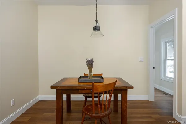 a view of a workspace with furniture and wooden floor