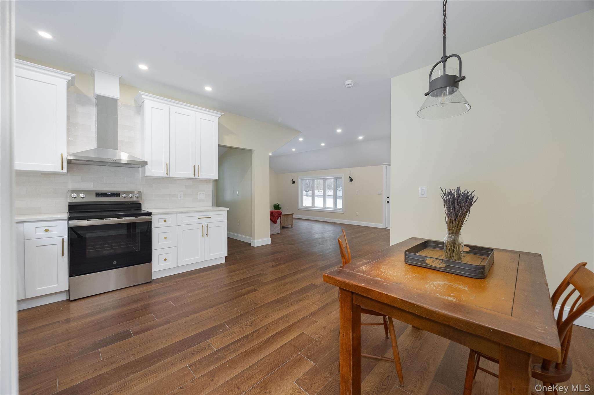 534-536 River Road Rhinebeck, NY 12572 - Photo 9 of 37 a kitchen with stainless steel appliances a kitchen island hardwood floor sink stove and wooden floor