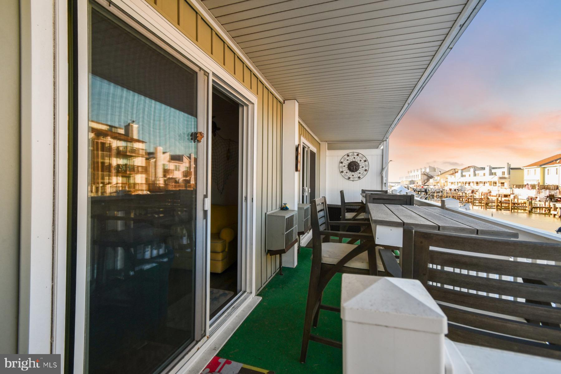 722 Mooring Road, Unit A104 Ocean City, MD 21842 - Photo 2 of 33 a porch with chairs and table