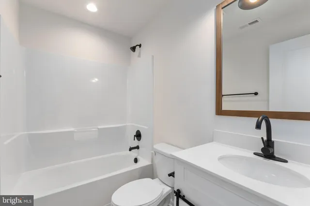 a bathroom with a sink toilet and bathtub