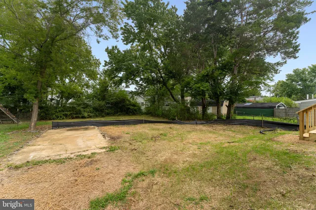 a view of a yard with swimming pool