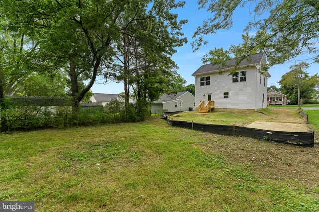 a view of a house with swimming pool and trees