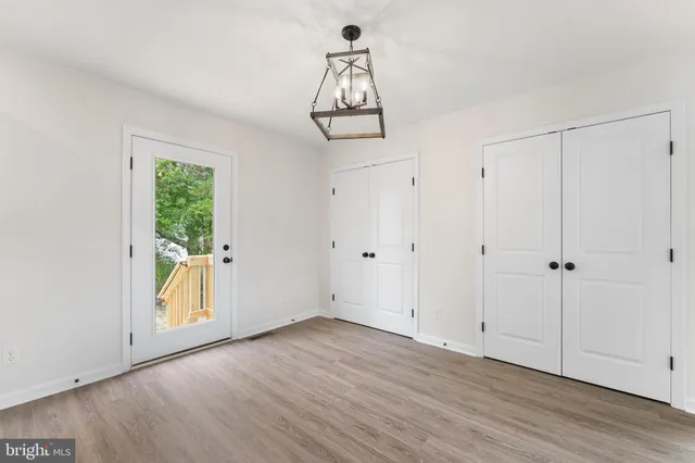 a view of an entryway with wooden floor