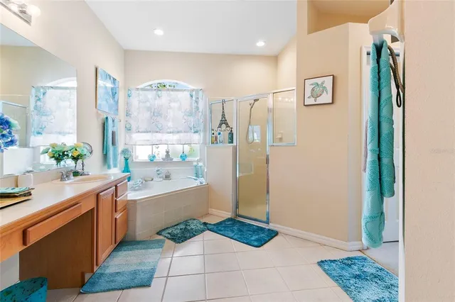 a spacious bathroom with a granite countertop sink a mirror and a shower
