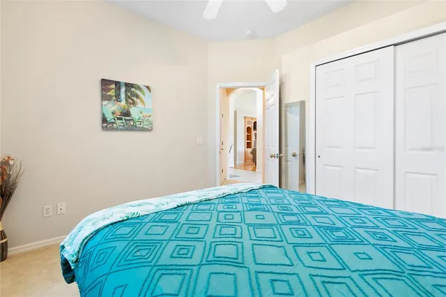 a bedroom with a bed and a painting on the wall